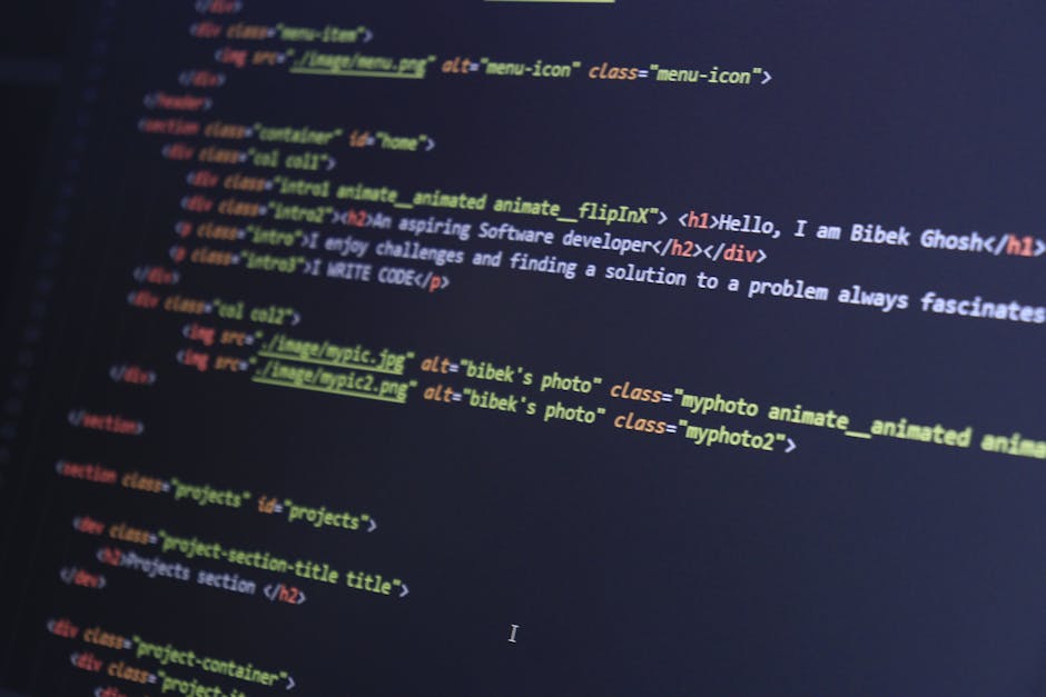 A person wearing a light blue shirt is seated at a desk, engaged in a home relocation or packing process for a move within the UK. They are working on a laptop that displays lines of code or text in m